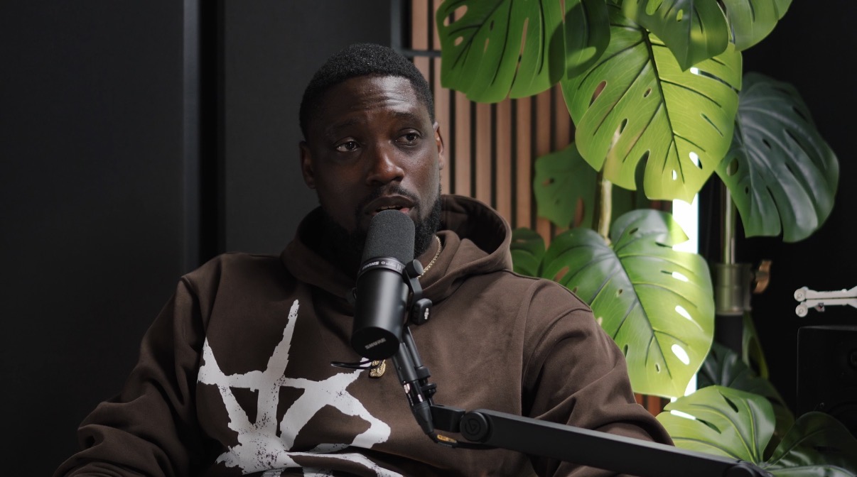 Ming speaking into a microphone in the podcast studio