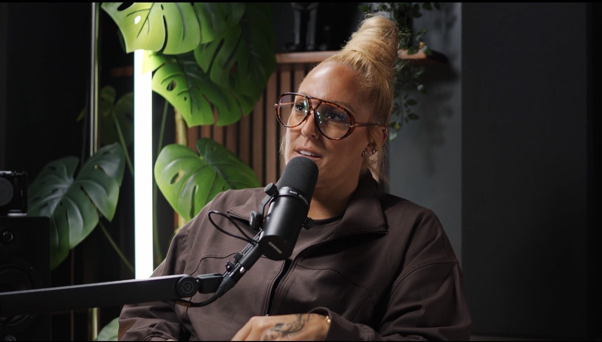 Steph speaking into a microphone in the podcast studio